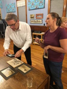 Terje and Amada Schott sharing family pictures at the Sons of Norway.