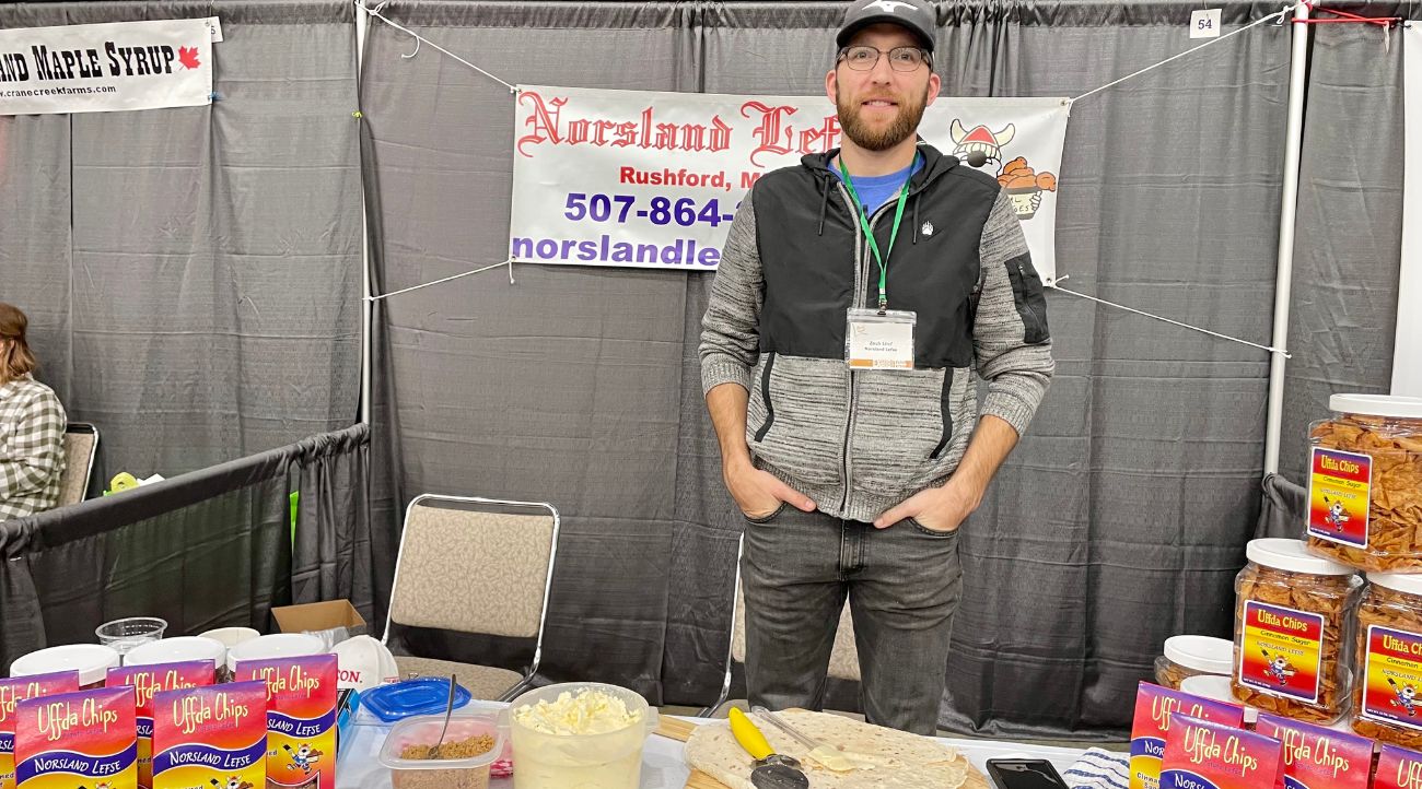 Zach Lind, General Manager of Norsland Lefse, mans the company booth at a recent FEAST event in Rochester.