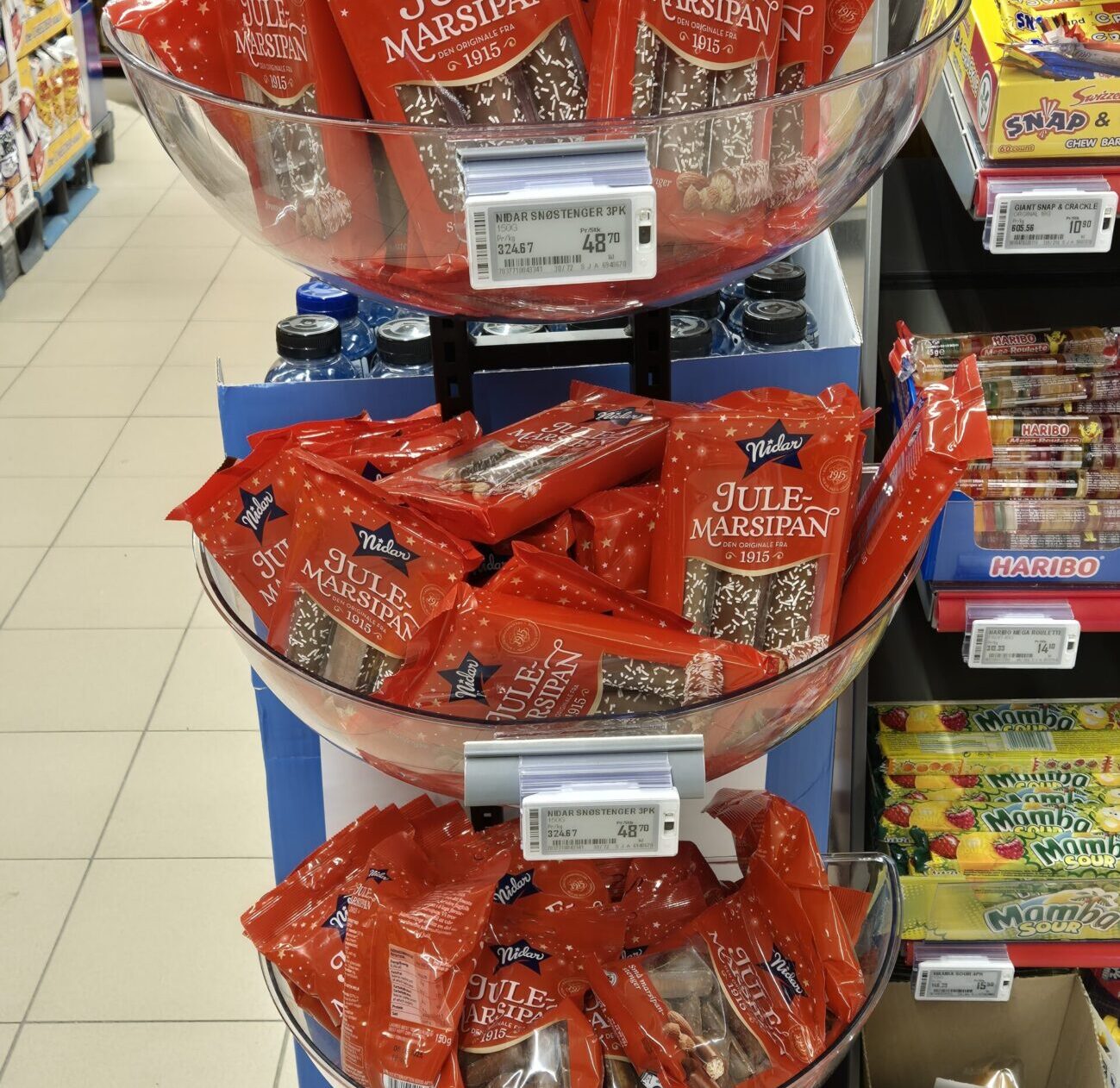 Racks of marzipan candies in a Norwegian grocery store.