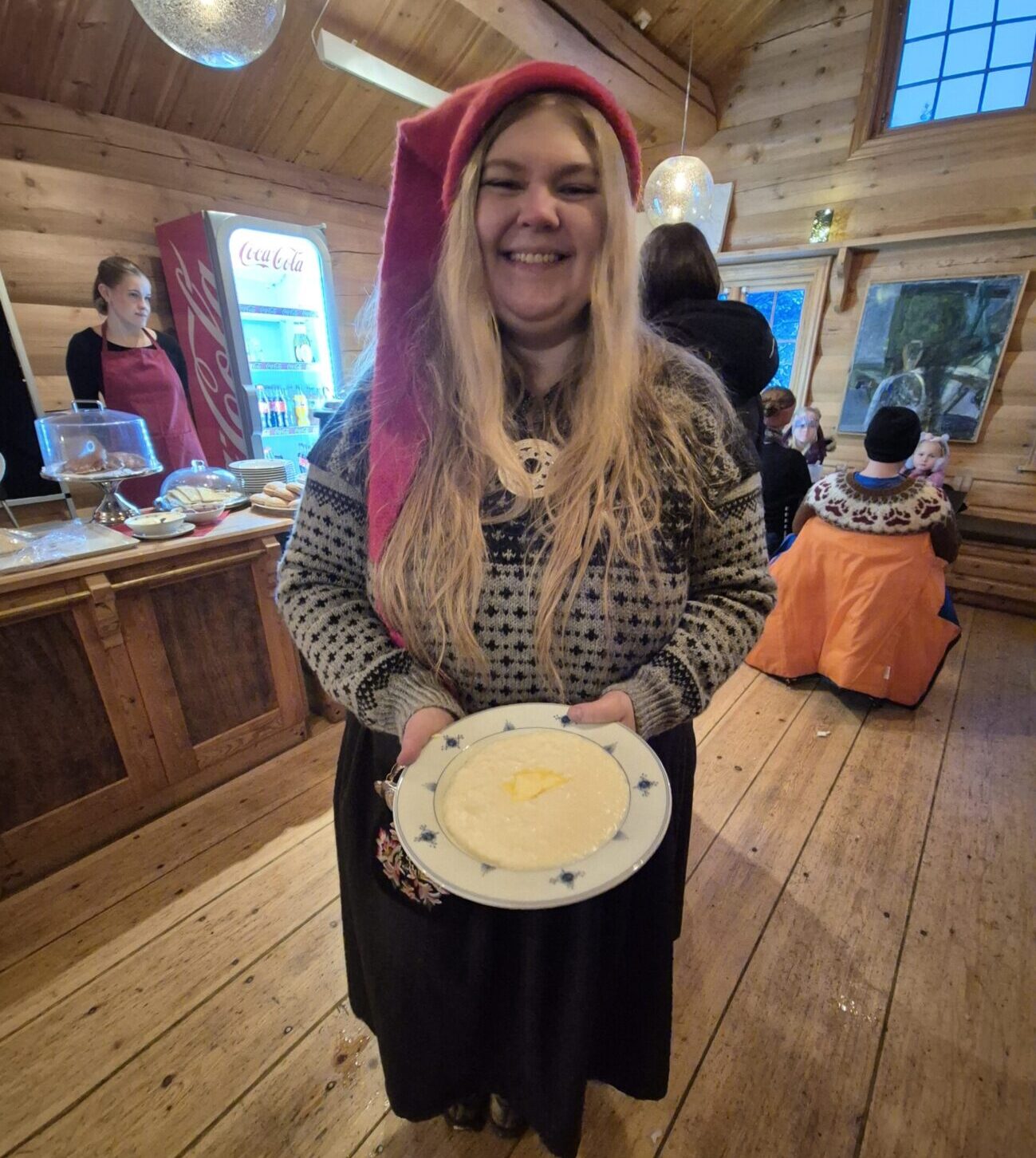 Woman in elf costume holds a bowl of porridge.