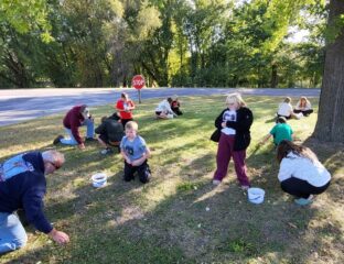 kids collecting acorns in a park