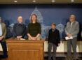 woman at podium with other adults surrounding her, announcing a minnesota law suit