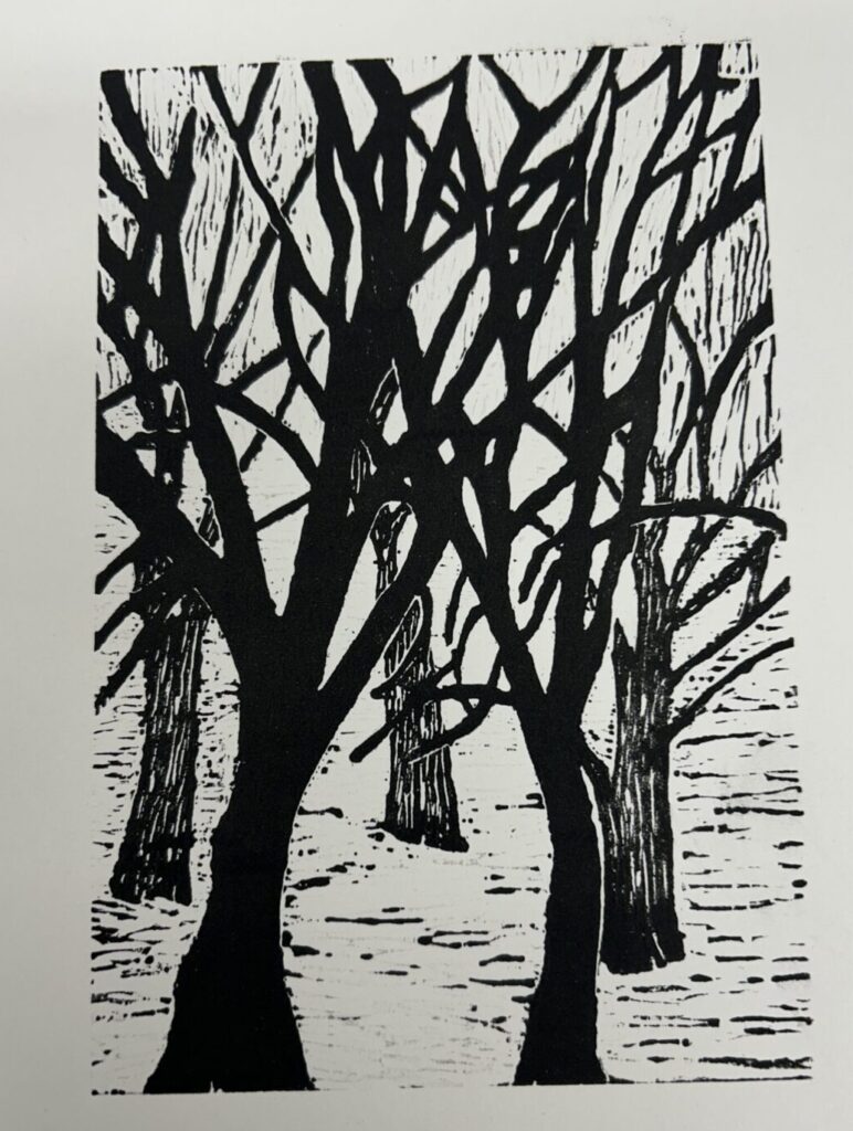 A black and white art print of trees with no leaves in a snowy field.