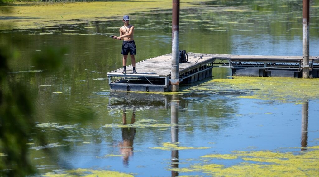 man fishing from mississippi river dock