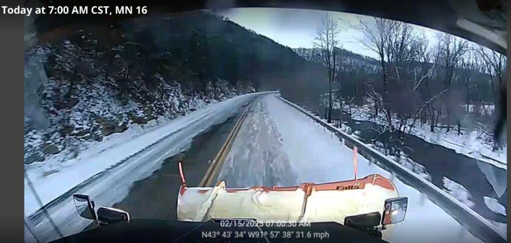 snowplow view of an icy highway