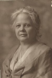 A black and white photo of a woman with gray hair.