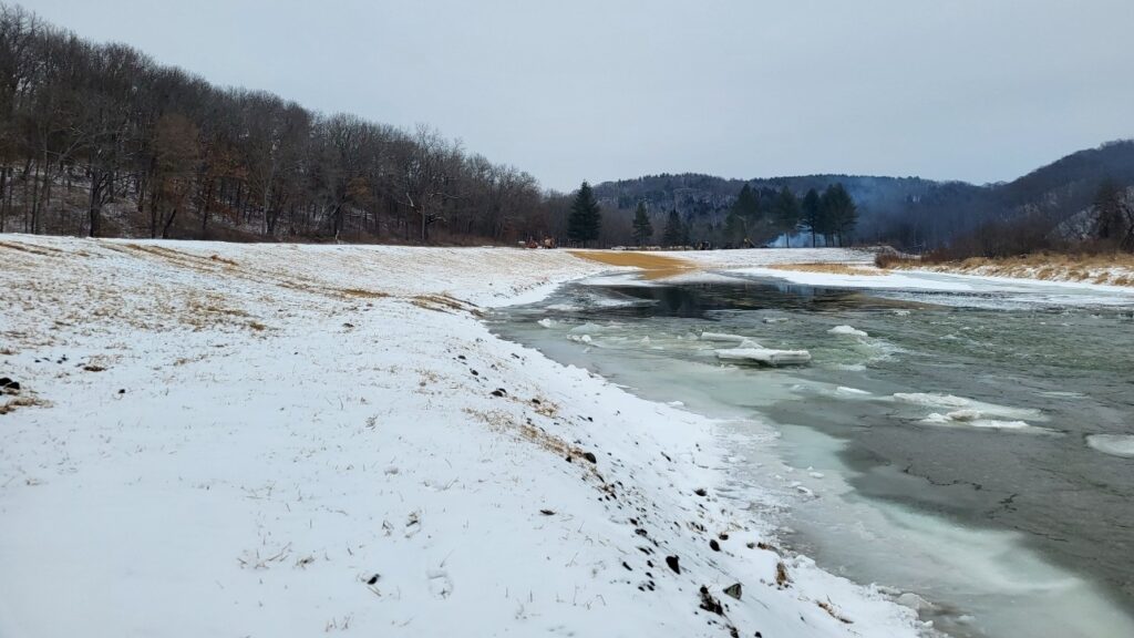 snow packed riverbank