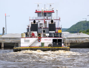 tug going through lock and dam