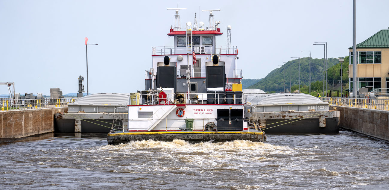 tug going through lock and dam