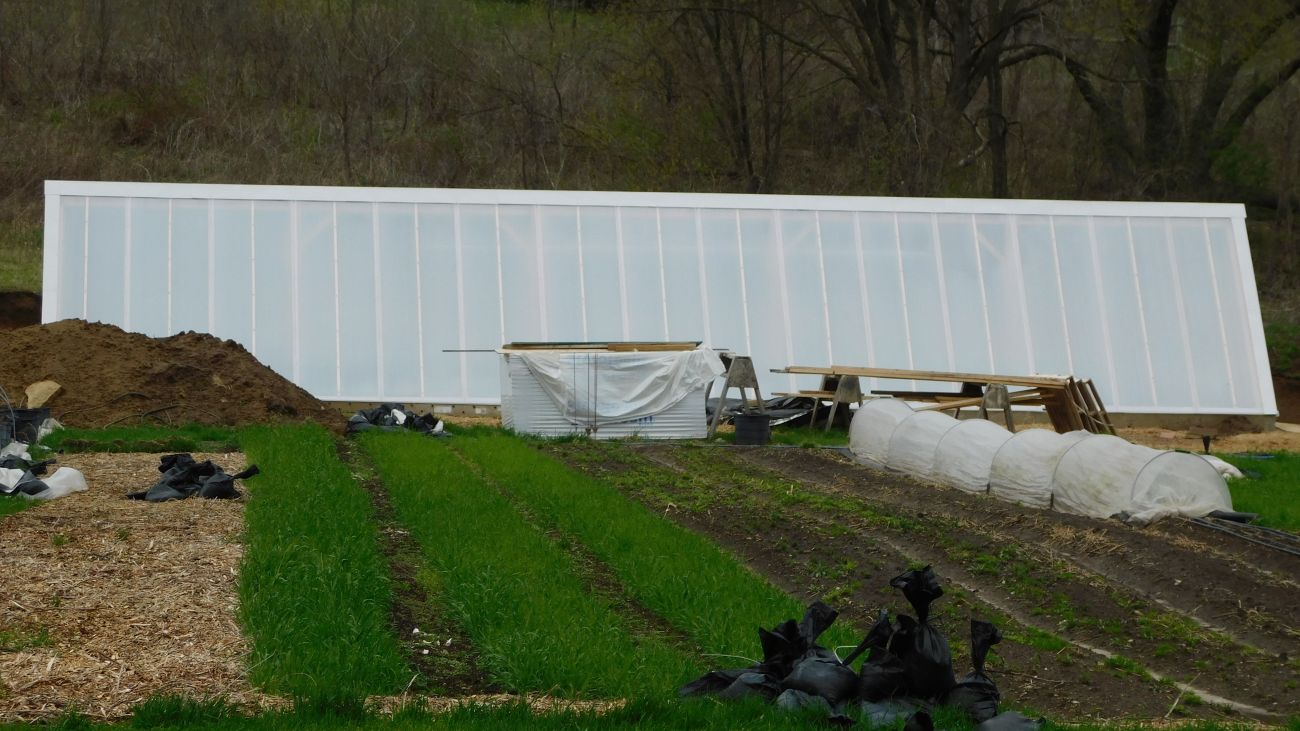 A long slanted white roof covers a nursery.