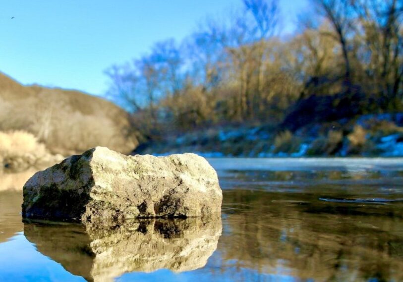 On cold winter days, ice creeps slowly from the shore toward the main channel of the Root River near Peterson. (Photo by Craig Johnson)