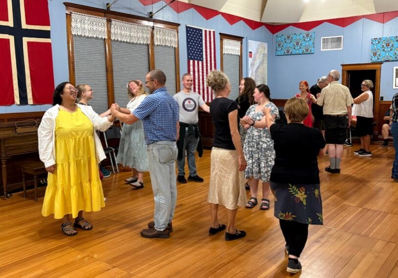 Hero Pairs of dancers practicing square dancing on a wooden dance floor.