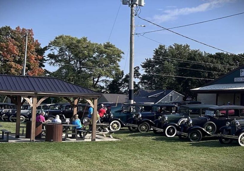 Model A cars and people at shelter