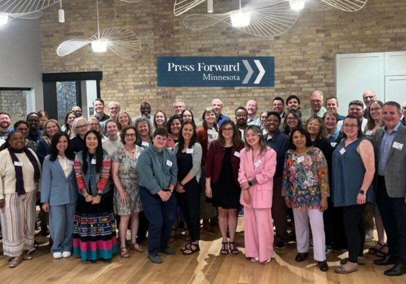 80+ people posing for group photo at Press Forward MN event