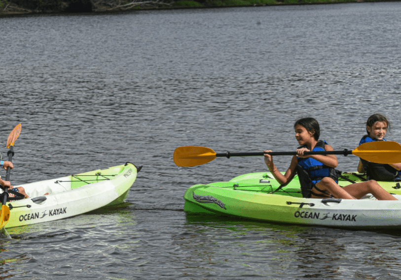 PHOTO 1 Base Camp <span style="font-size: 14px; color: #6c6b6b; ">Brady Thill, 9, Josie Swing, 10, and Harper Hines, 10, all of Galesville, Wis. have fun in kayaks during the BaseCamp event in Winona. (Photo by John Weiss)</span>
