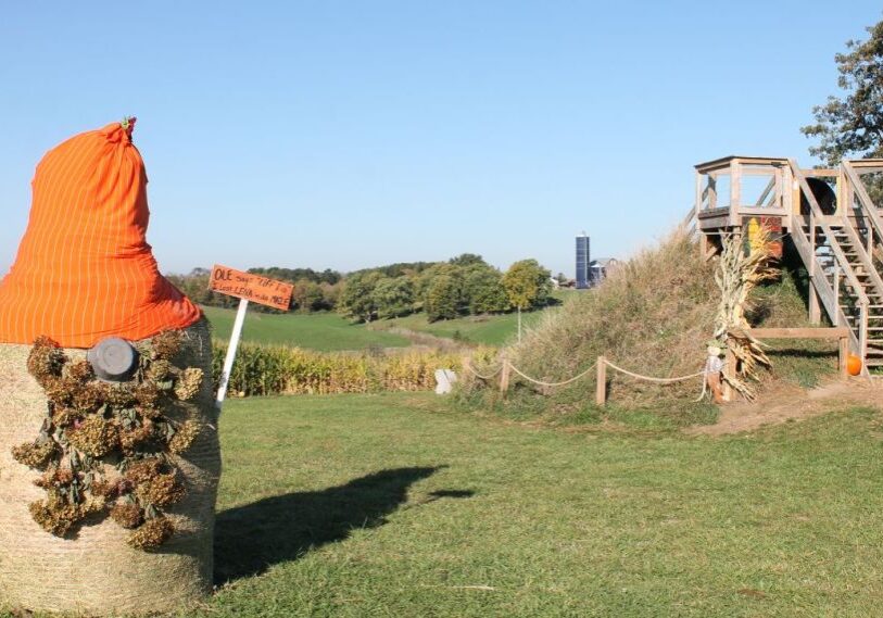 PHOTO 1 Corn Maze A haybale is transformed into a gnome with pinecone bear and orange hat.