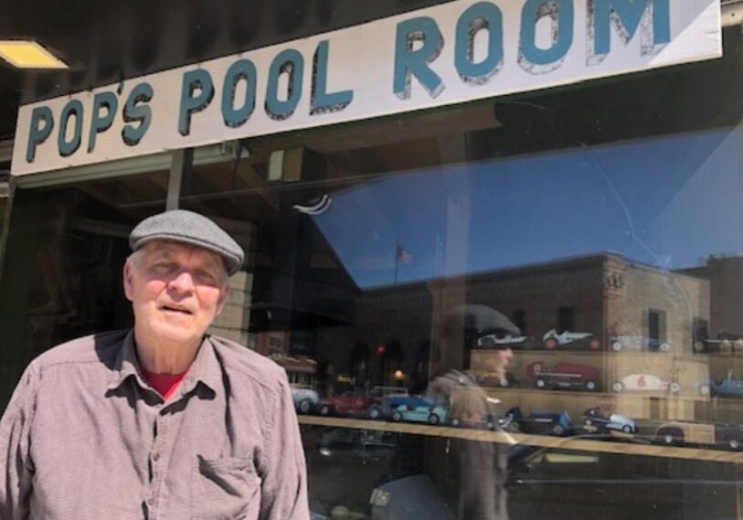 PHOTO 1 Gordie Tindall Outside Pool Hall <span style="font-size: 14px; color: #6c6b6b; ">Gordie Tindall of Lanesboro, Minnesota, in front of his pool hall. (Photo by Steve Harris)</span>