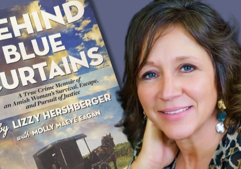 Woman with brown hair and blue eyes leans on her right hand. Behind her in the background is an enlarged photo of her book cover.