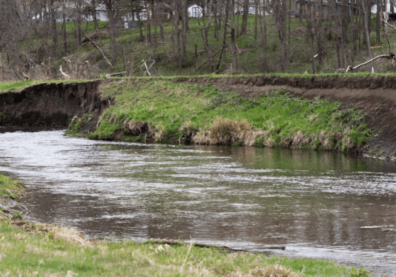 PHOTO 1 Mill Creek Erosion <span style="font-size: 14px; color: #6c6b6b; ">Trees along the lowest part of Mill Creek were cut down a few months ago, but part of the trunks were left so the roots and lower trunk could be buried in the creek’s bank for trout habitat and to protect the shoreline from erosion. (Photo by John Weiss)</span>