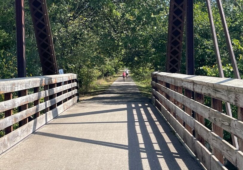 PHOTO 1 couple on bridge The Root River Trail is a tourist destination for recreationalists in southeast Minnesota. A six-mile trail expansion will extend the trail from Harmony to the Iowa border. (Photo by Renee Bergstrom)