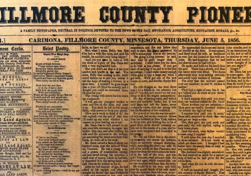 A yellowed, aged newspaper front page titled “Fillmore County Pioneer” fills the frame, printed in bold, decorative serif lettering across the top. Beneath the title, smaller text reads “Carimona, Fillmore County, Minnesota, Thursday, June 5, 1856,” along with volume and issue numbers. The page is densely packed with narrow columns of small black text, including sections labeled “Business Cards” and “Select Poetry.” Advertisements for goods and services appear along the left column, while poetry and articles fill the center and right columns. The paper shows visible wear and discoloration, emphasizing its historical age.