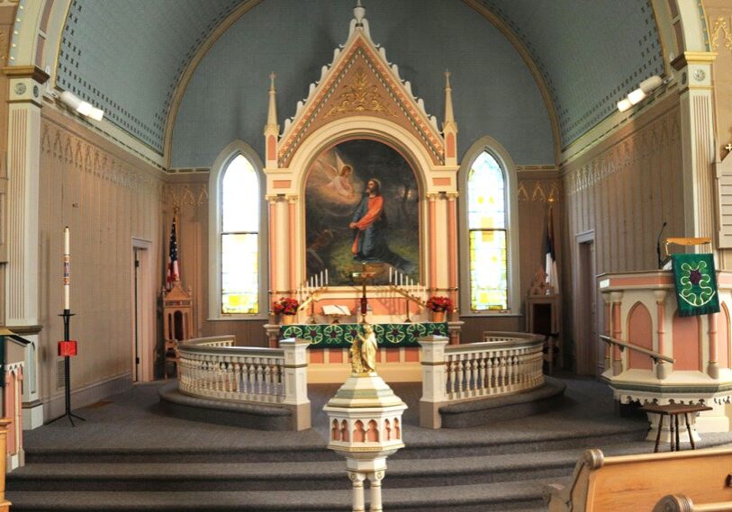 A painted church altar with lots of ornamentation.
