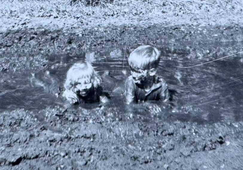 photo 1 - brother and sister in mud two kids playing in muddy water